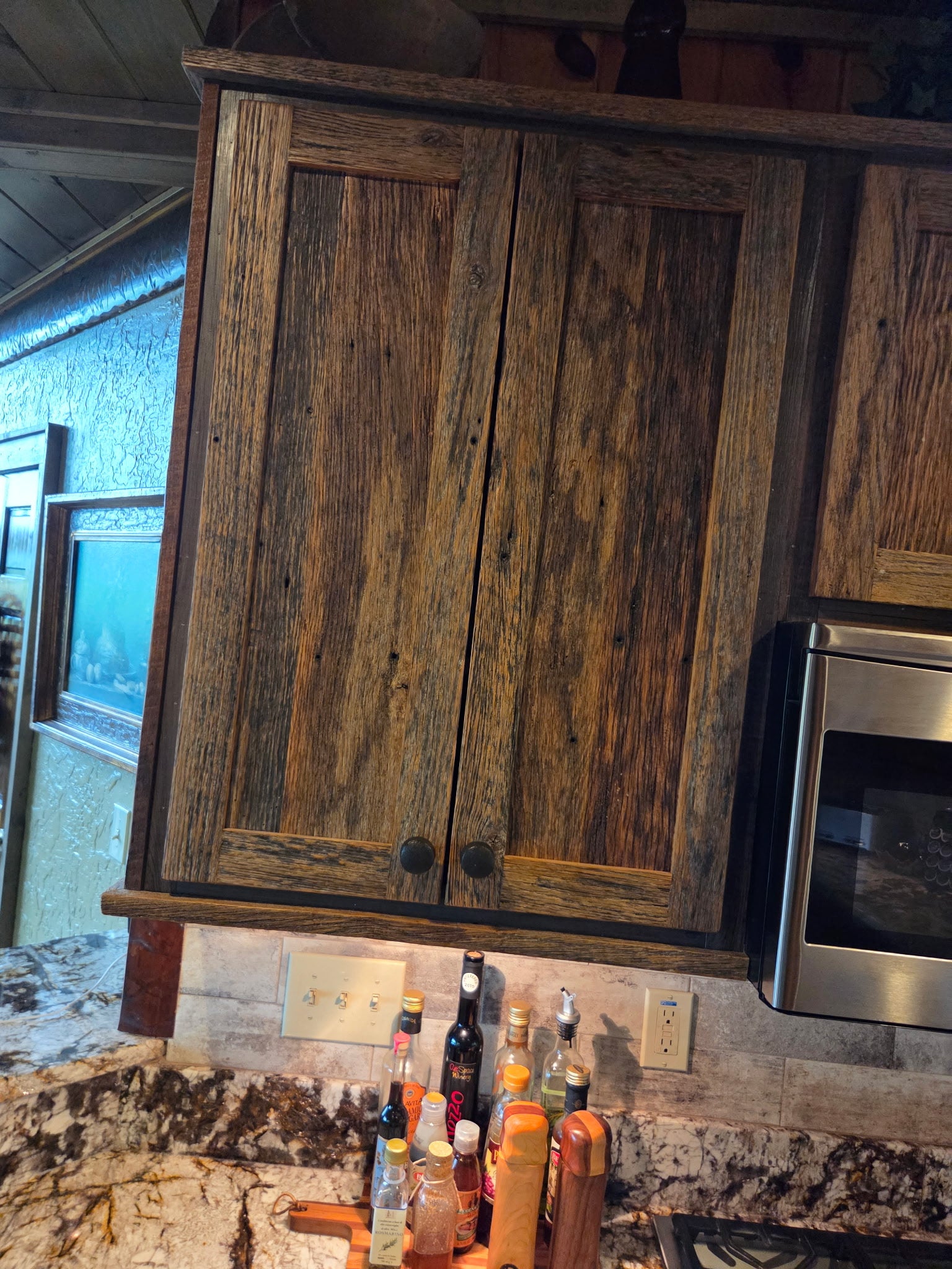 Reclaimed barnwood cabinet doors in a mountain cabin kitchen