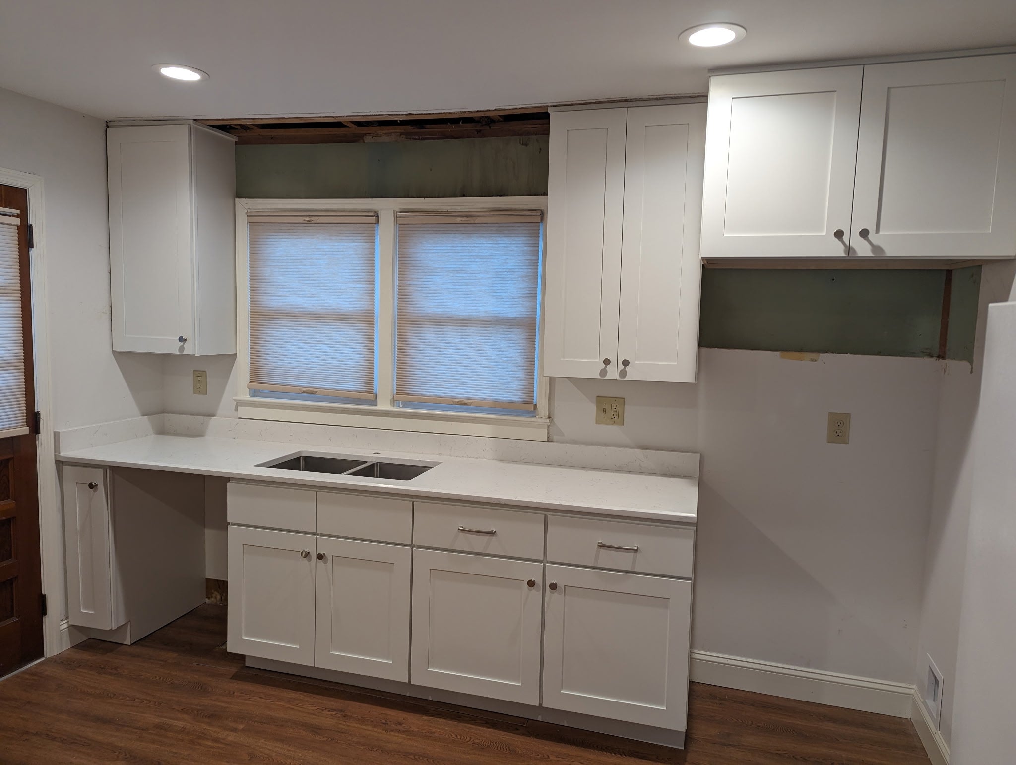 White shaker kitchen cabinets with quartz countertop and stainless sink