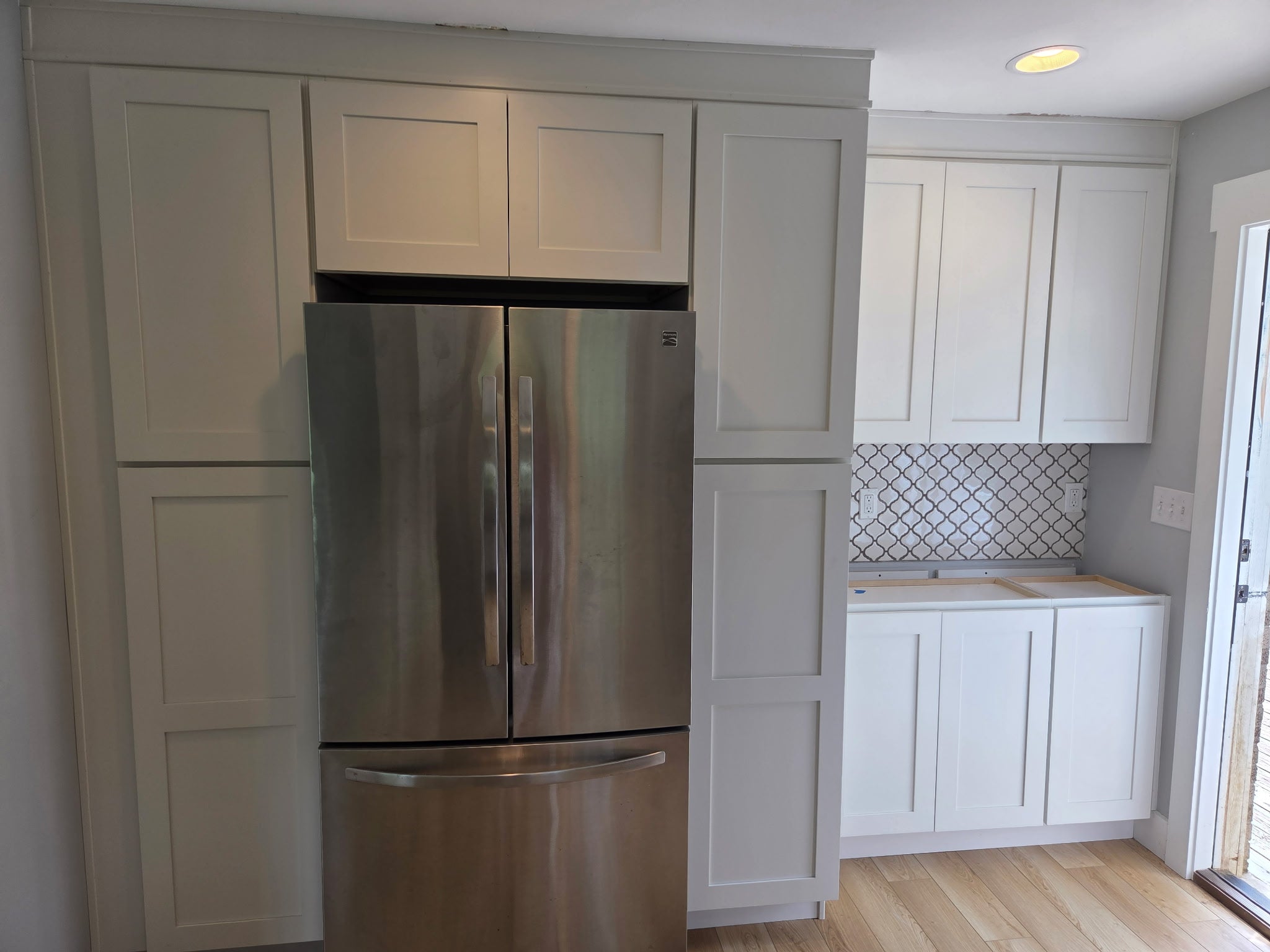 White shaker cabinet refrigerator surround and pantry in a Waynesville NC kitchen